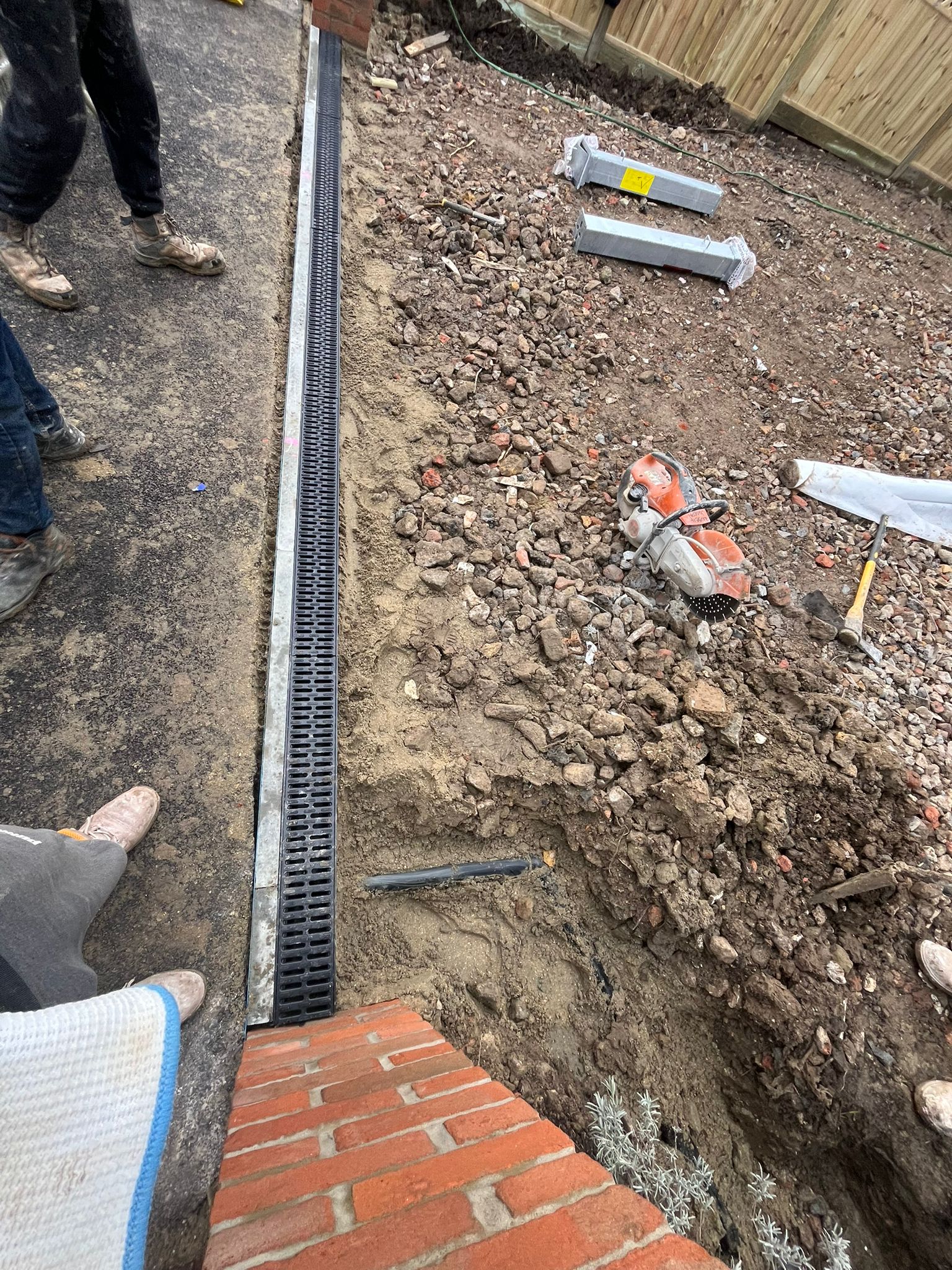 Driveway groundwork with a new drainage channel installed before block paving