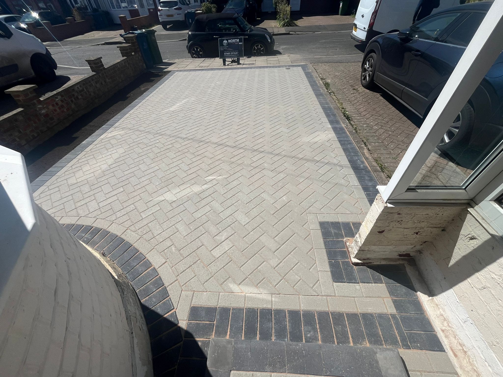 Finished block paving driveway at dusk with garden planters