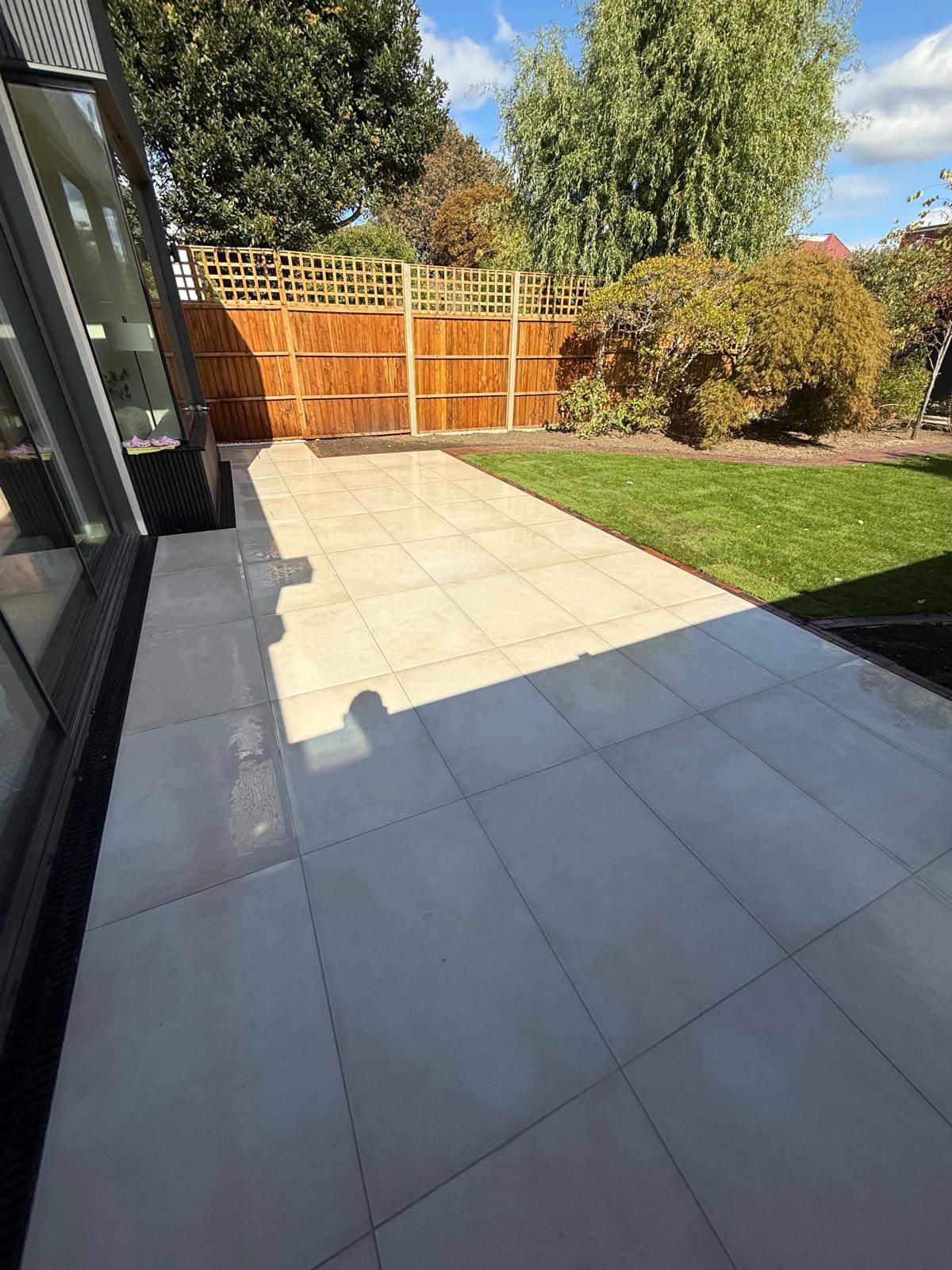 Finished porcelain patio leading onto the lawn