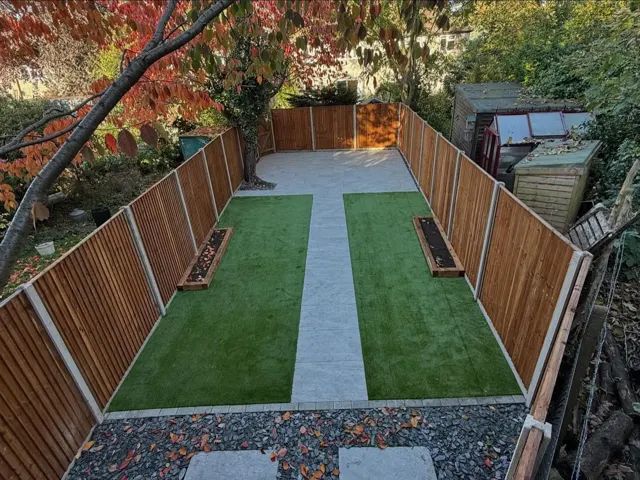 Garden with artificial grass, central path and new fencing