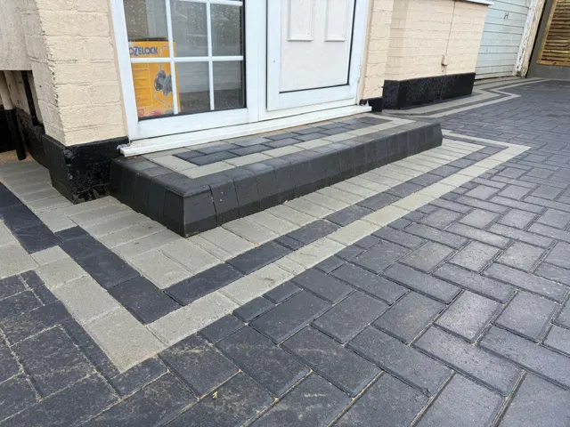 Charcoal block paving with silver soldier-course border