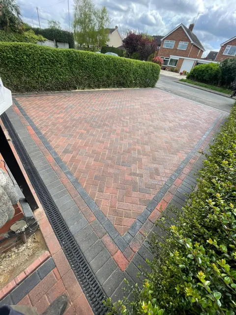 Red block paving driveway with charcoal border