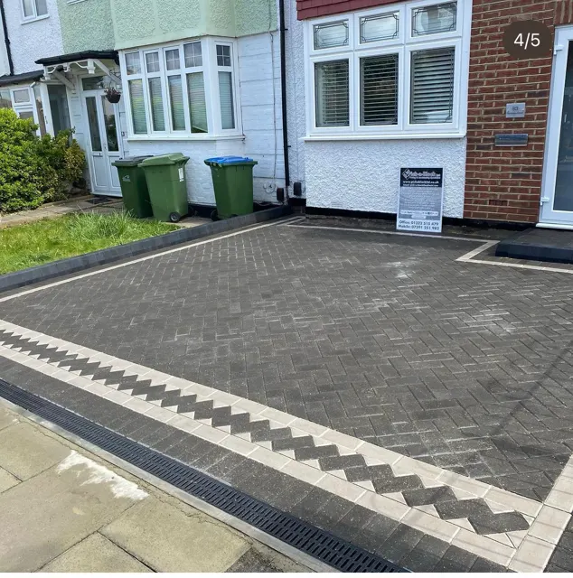 Charcoal block paving driveway with white banding