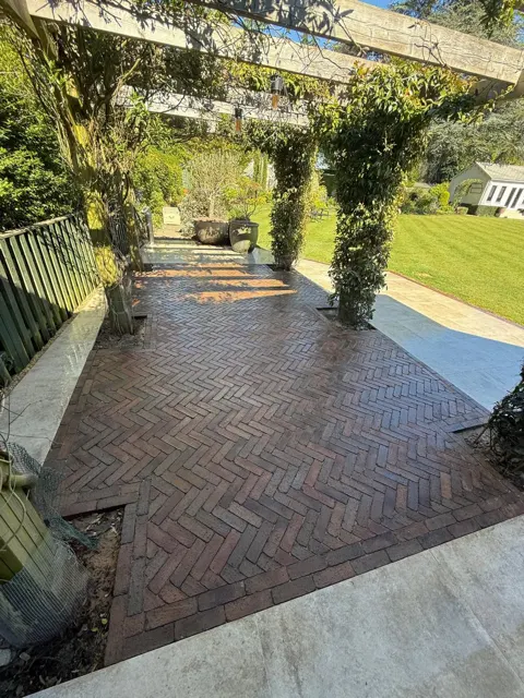 Block paved garden patio surrounded by planting