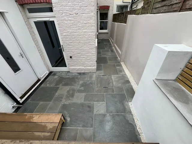 Slate-grey paving side return with feature wall